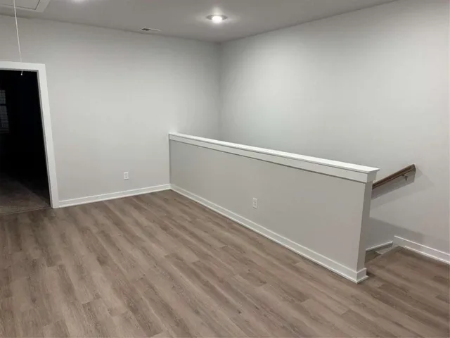 a view of hallway with wooden floor