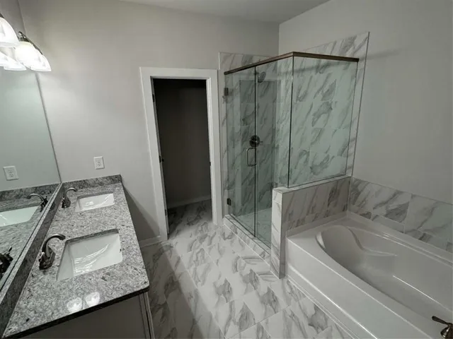 a bathroom with a granite countertop sink mirror and shower