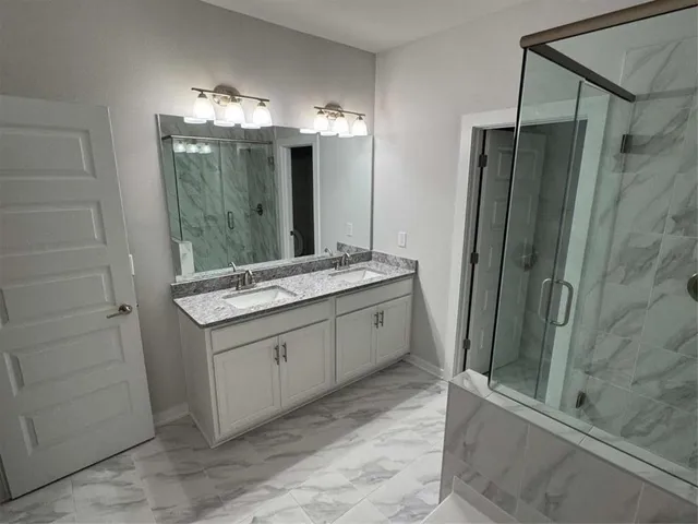 a bathroom with a sink and a shower