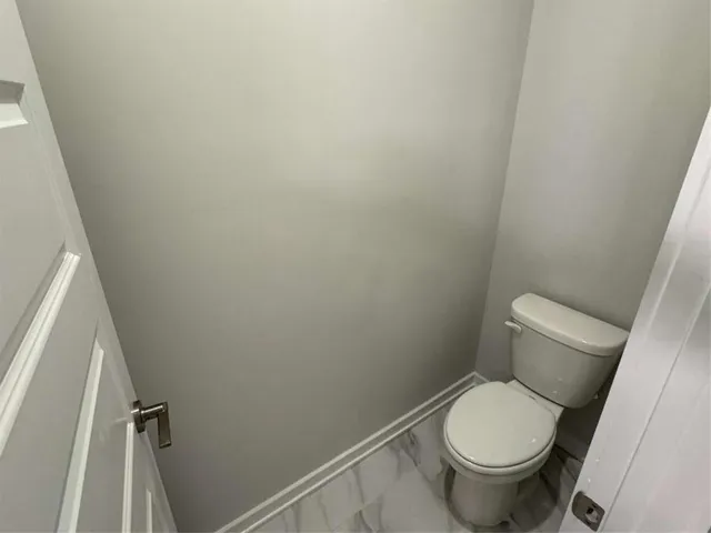 an empty room with wooden floor and entrance