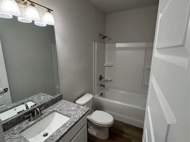 a toilet sitting next to a bath tub