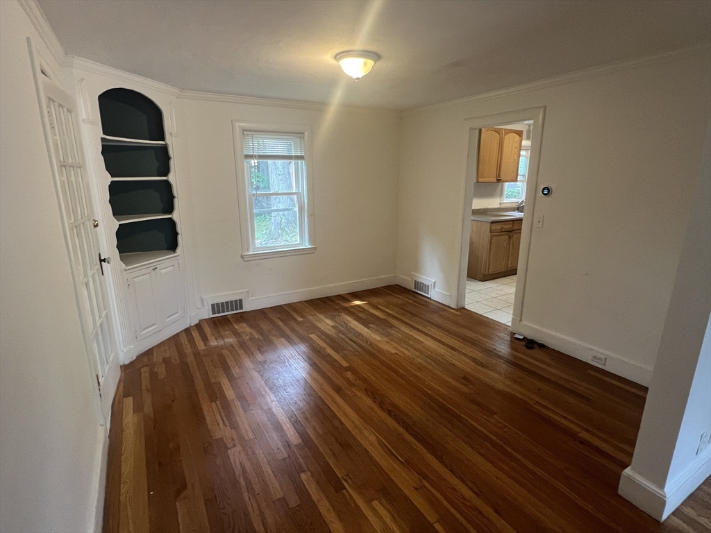 223 Woodcliff Road Newton, MA 02461 - Photo 5 of 15 an empty room with windows and closet