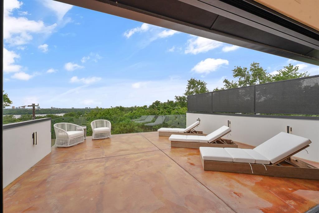 9457 Waterview Road Dallas, TX 75218 - Photo 3 of 25 Expansive outdoor patio featuring stained concrete flooring and a partial glass railing