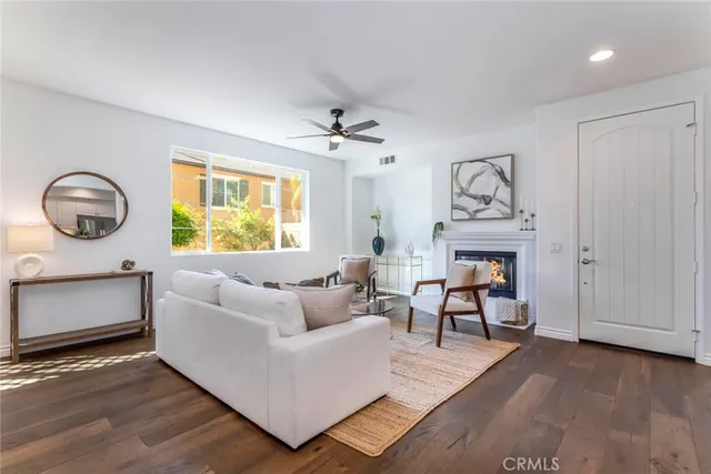 a living room with furniture a clock and a window