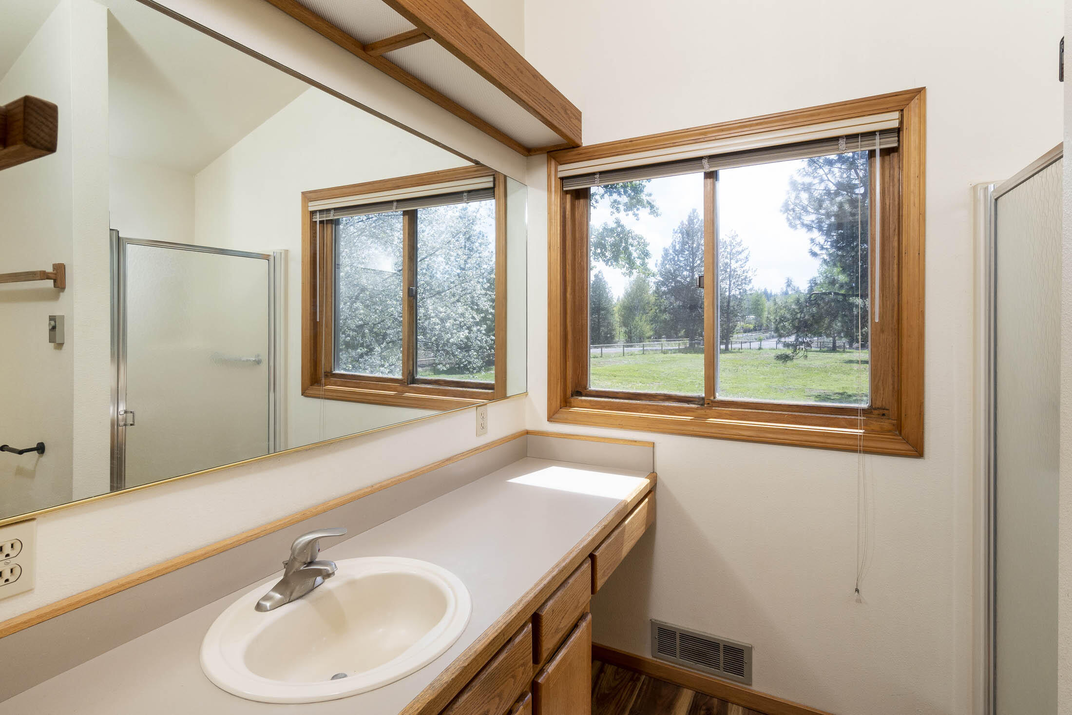 60603 Woodside Road Bend, OR 97702 - Photo 26 of 36 a bathroom with a sink and a window