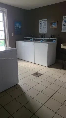 a view of a room with a projector and wall