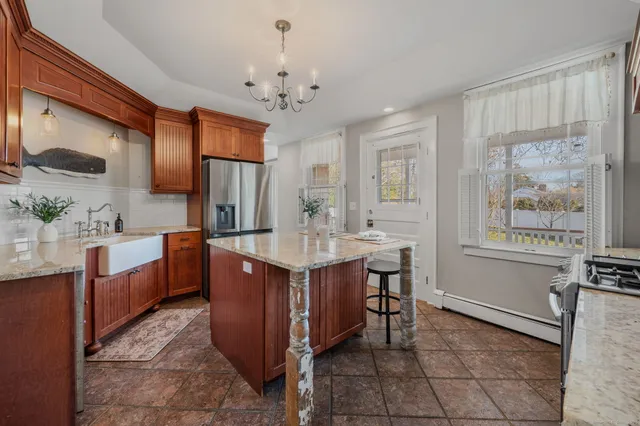 a spacious bathroom with a granite countertop sink a toilet a mirror and vanity