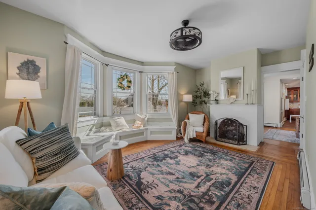 a living room with furniture and a fireplace