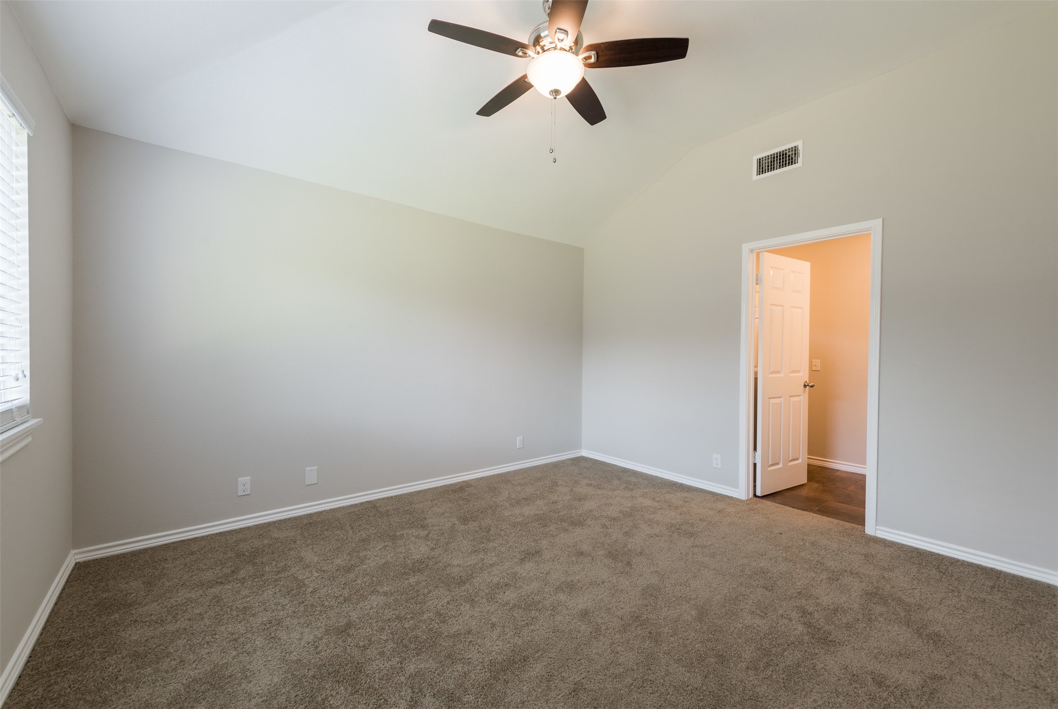 5703 Teri Road Austin, TX 78744 - Photo 9 of 16 an empty room with a window and a fan