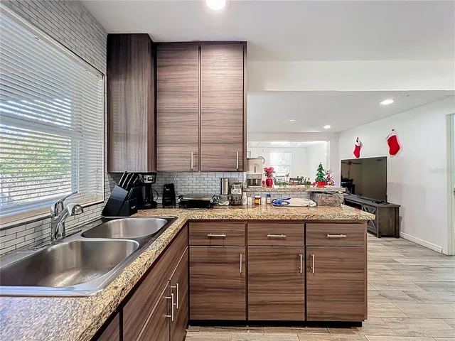 a kitchen with a sink stove and cabinets