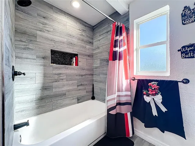 a bathroom with a bathtub and a shower