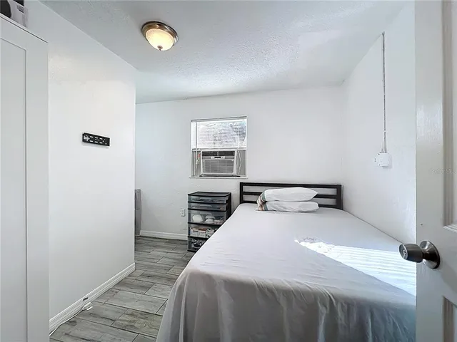 a bedroom with a bed and a chandelier