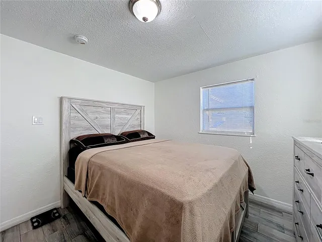 a bedroom with a bed and window