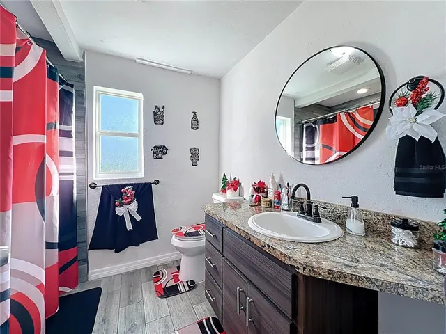 a bathroom with a sink vanity and a mirror
