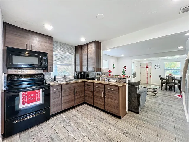 a large kitchen with lots of counter space and stainless steel appliances