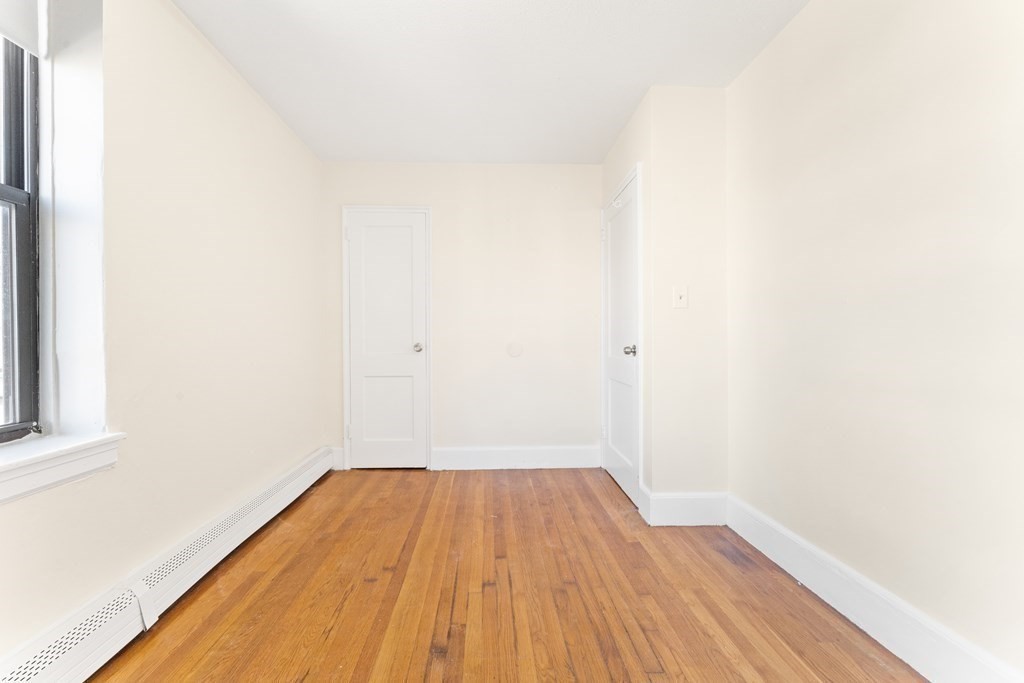 11 Victory Road, Unit 32 Boston, MA 02122 - Photo 8 of 16 a view of a room with wooden floor