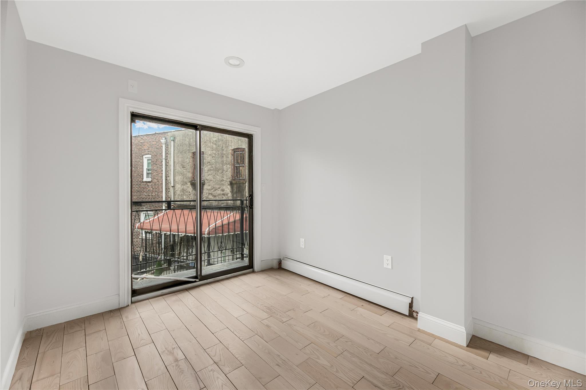 3067 Williamsbridge Road Bronx, NY 10467 - Photo 14 of 29 an empty room with wooden floor and windows