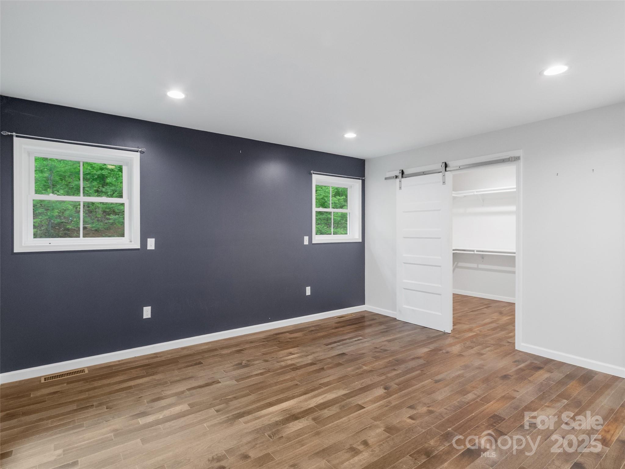 155 Pebble Ridge Road Spruce Pine, NC 28777 - Photo 15 of 39 a view of an empty room with wooden floor and a window
