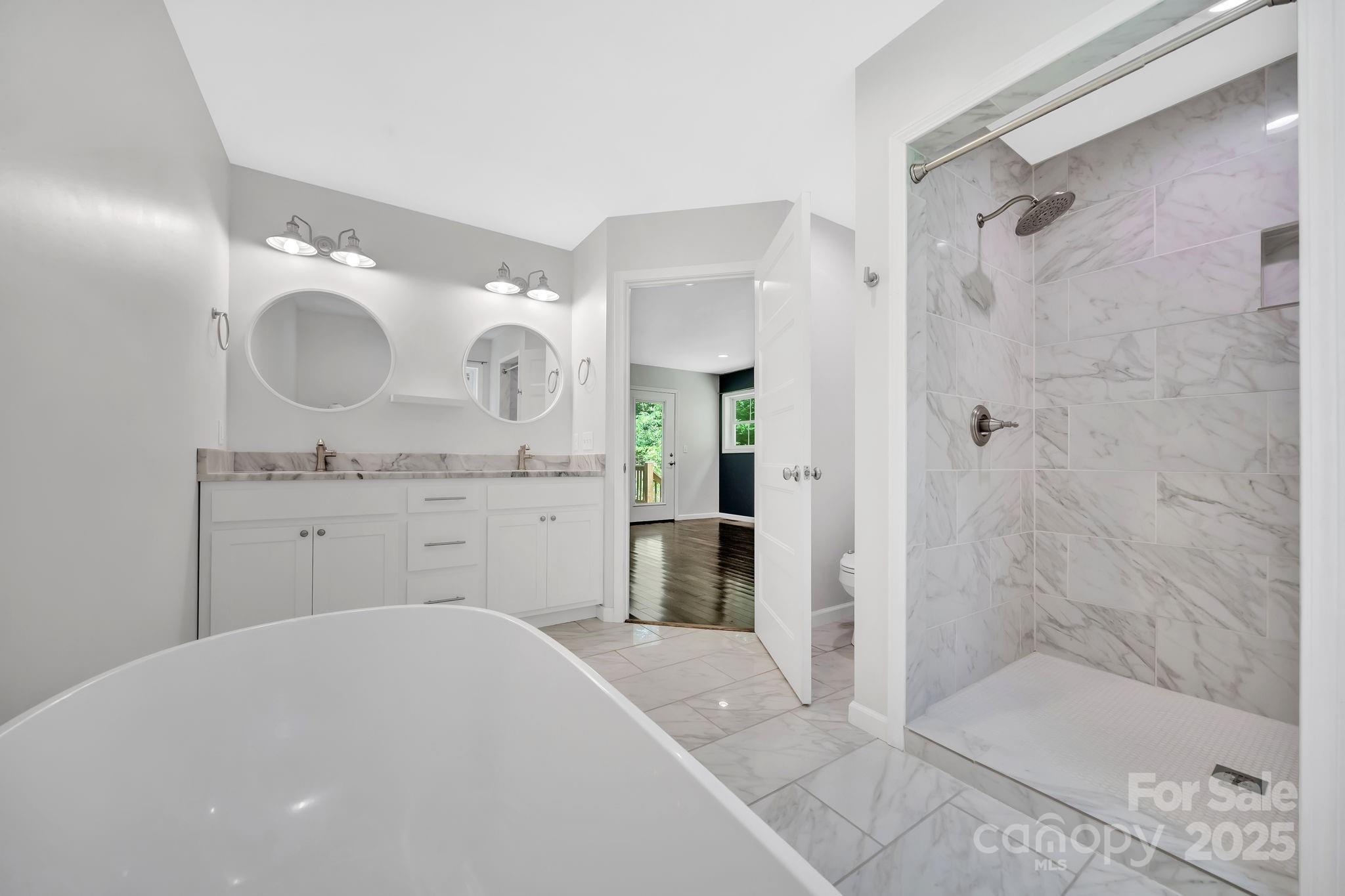 155 Pebble Ridge Road Spruce Pine, NC 28777 - Photo 17 of 39 a spacious bathroom with a sink mirror and a shower