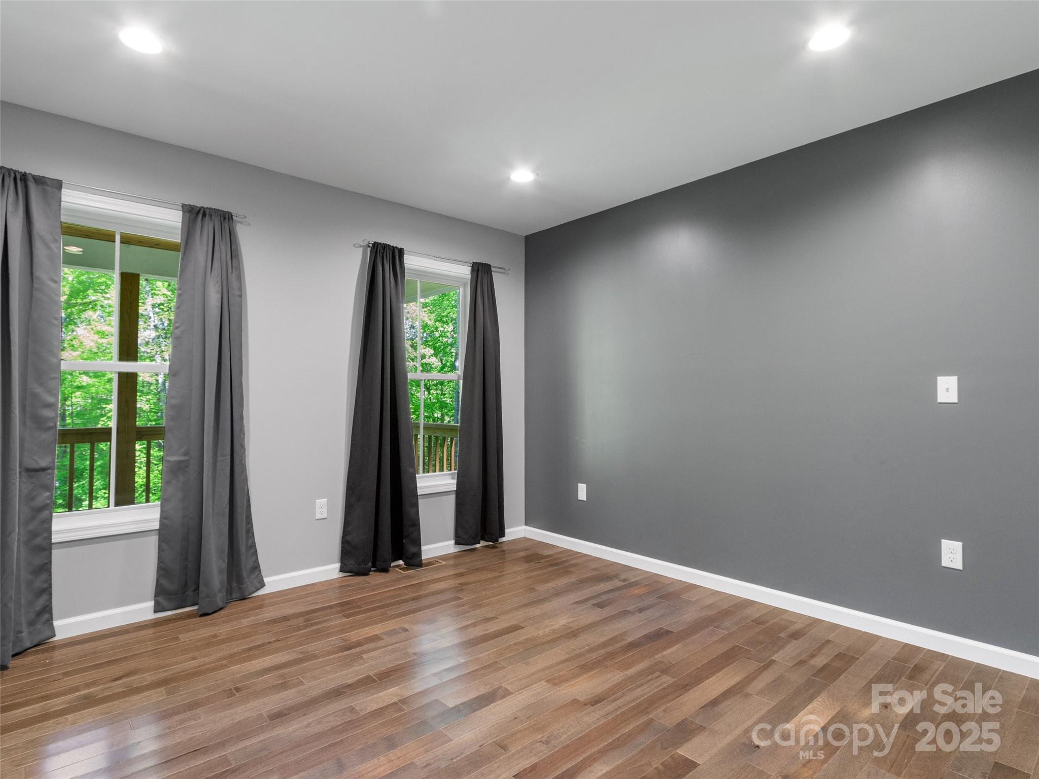 155 Pebble Ridge Road Spruce Pine, NC 28777 - Photo 22 of 39 a view of an empty room with wooden floor and a window
