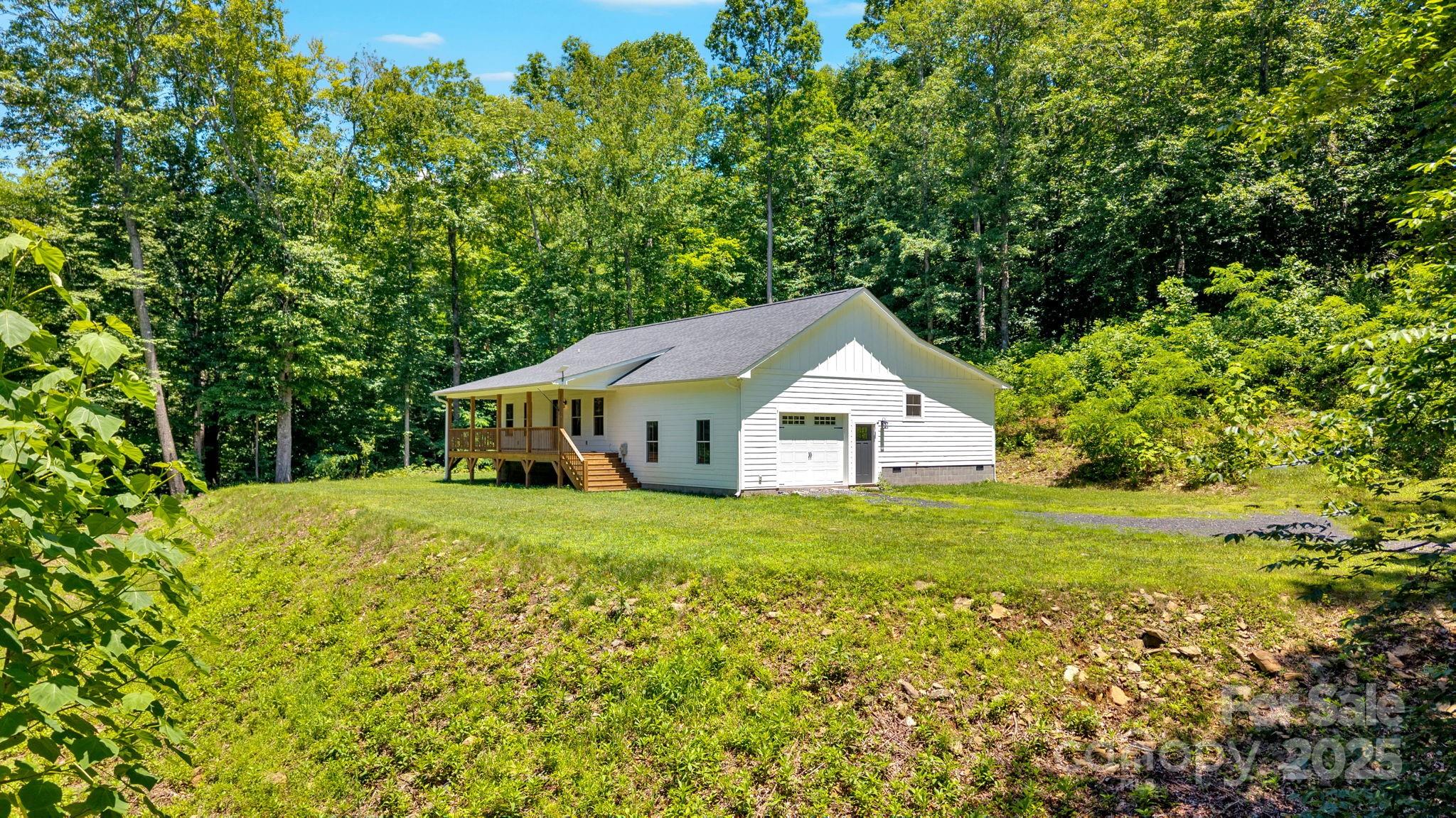 155 Pebble Ridge Road Spruce Pine, NC 28777 - Photo 4 of 39 a house with trees in the background