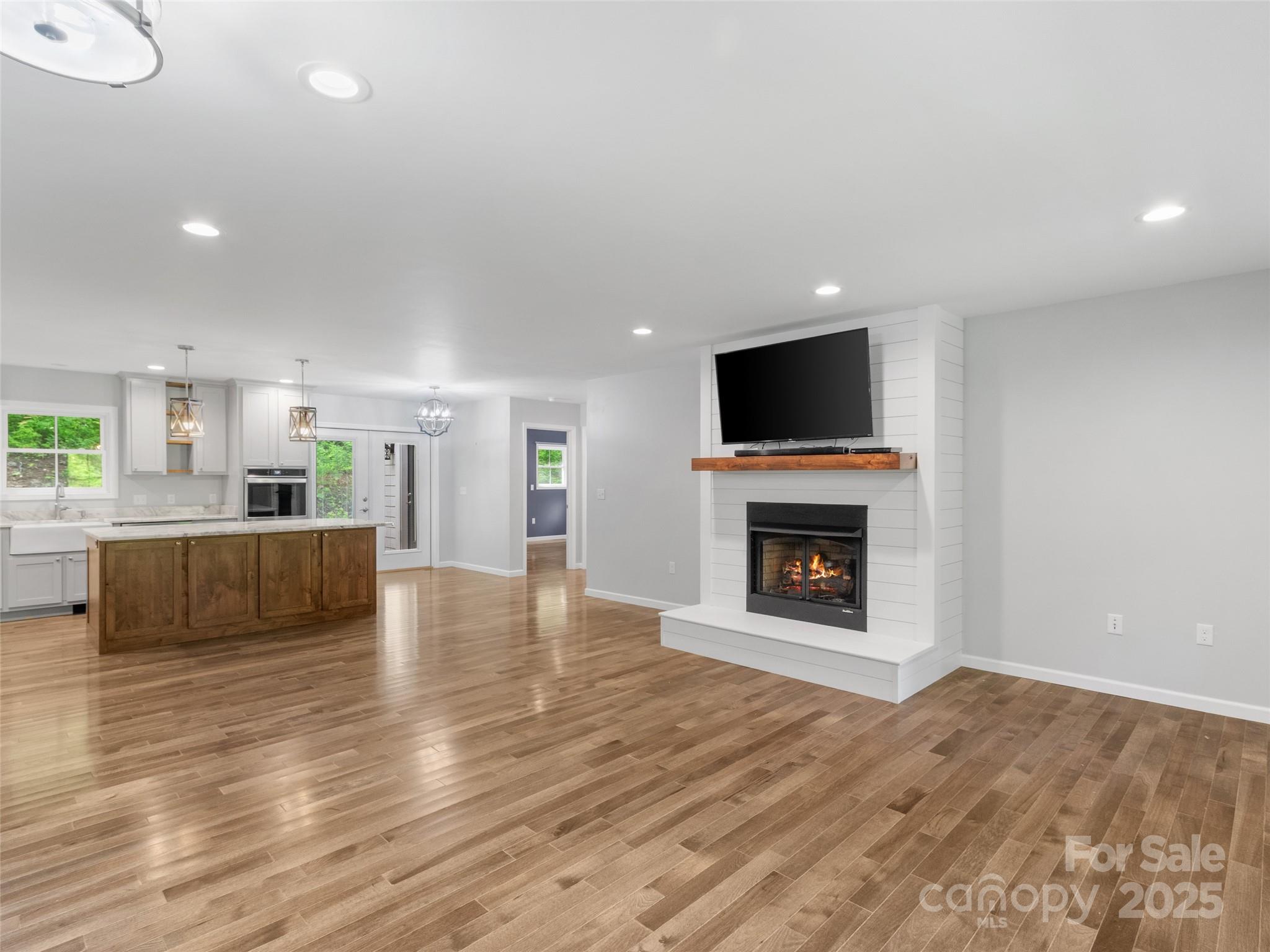 155 Pebble Ridge Road Spruce Pine, NC 28777 - Photo 7 of 39 a view of a kitchen with a fireplace a sink and a living room