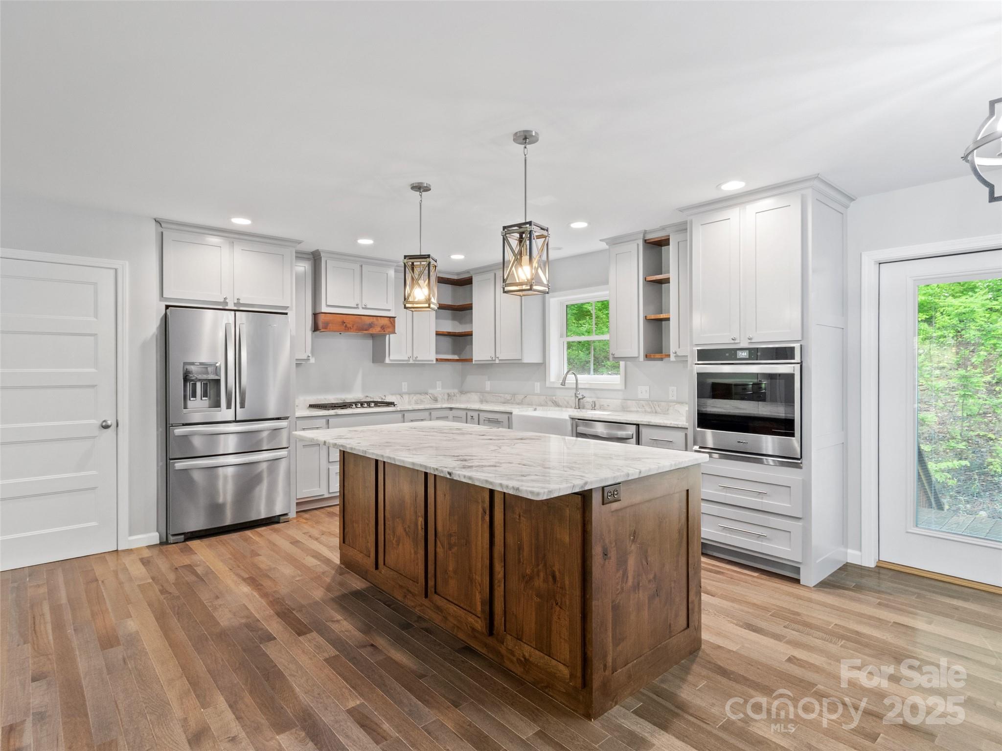 155 Pebble Ridge Road Spruce Pine, NC 28777 - Photo 9 of 39 a kitchen with kitchen island a sink stove and refrigerator