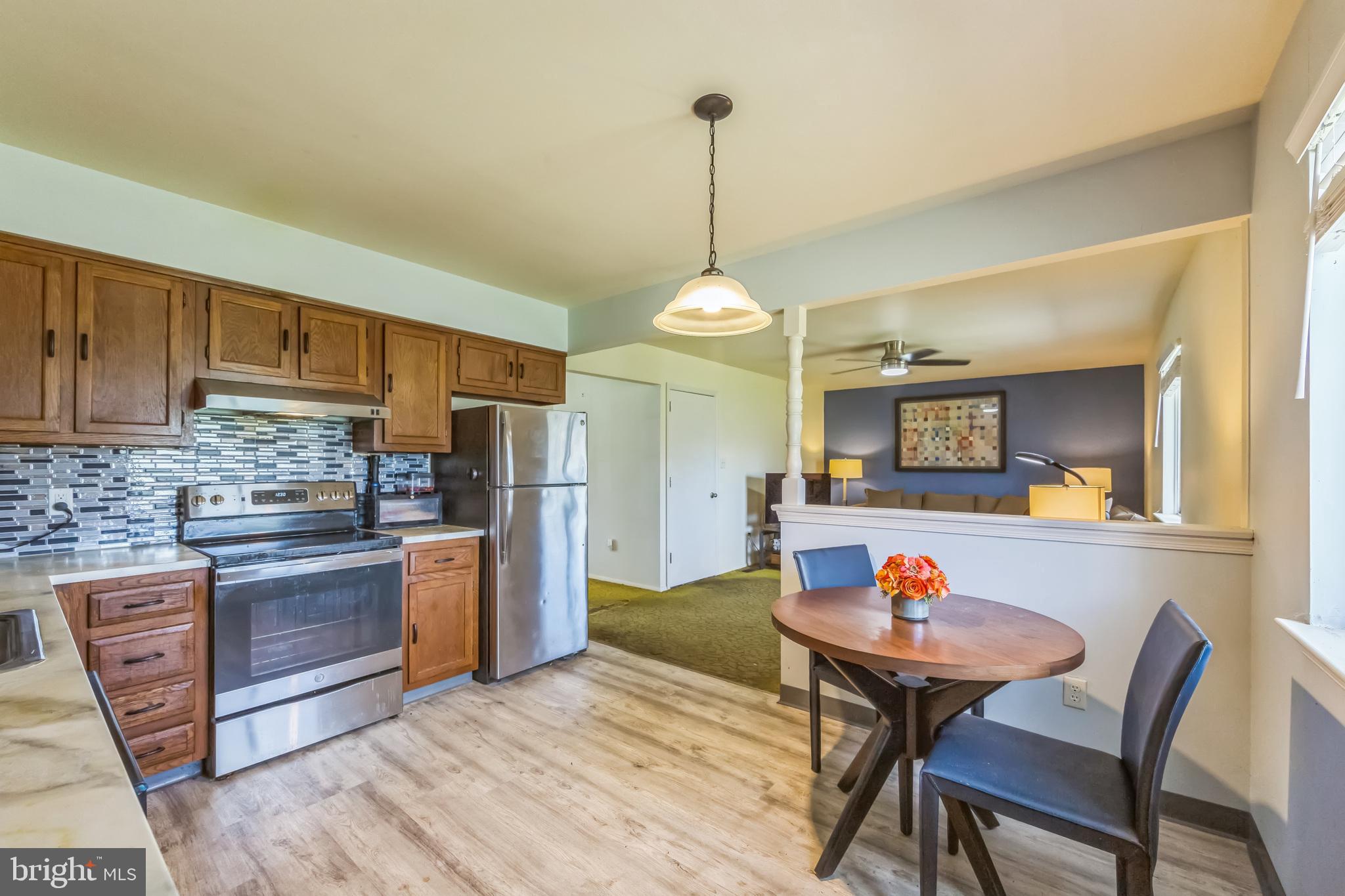 150 Red Stone Ridge Delran, NJ 08075 - Photo 19 of 28 a kitchen with stainless steel appliances wooden floor dining table and chairs