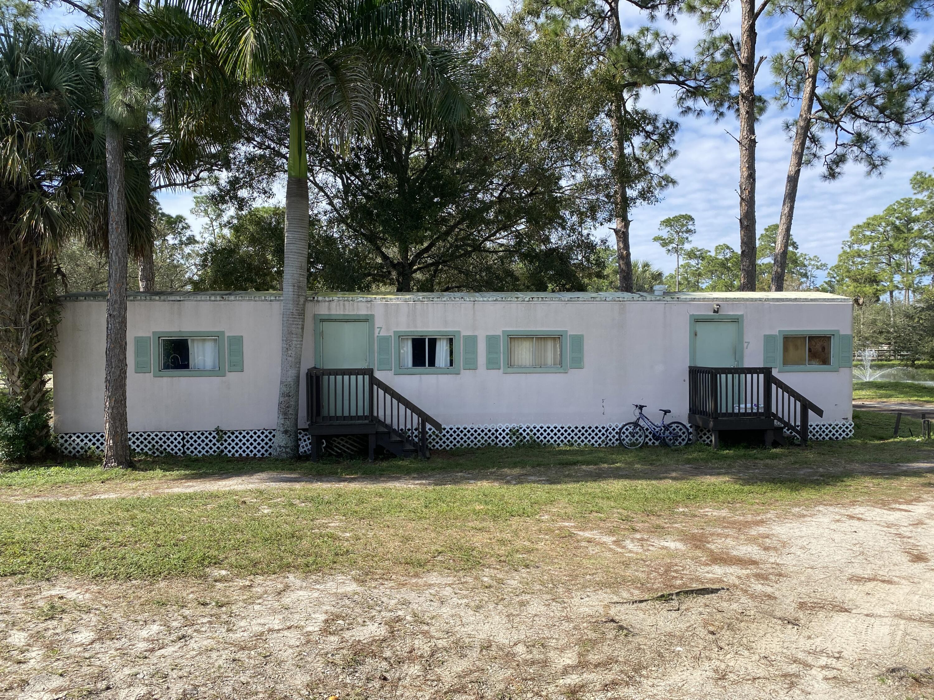 2141 B Road, Unit STUDIO 3 Loxahatchee Groves, FL 33470 - Photo 13 of 45 a view of a house with a yard