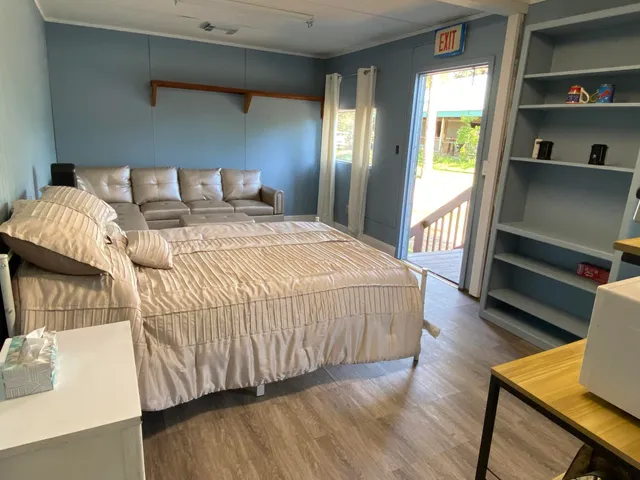 a bedroom with a bed and a couch