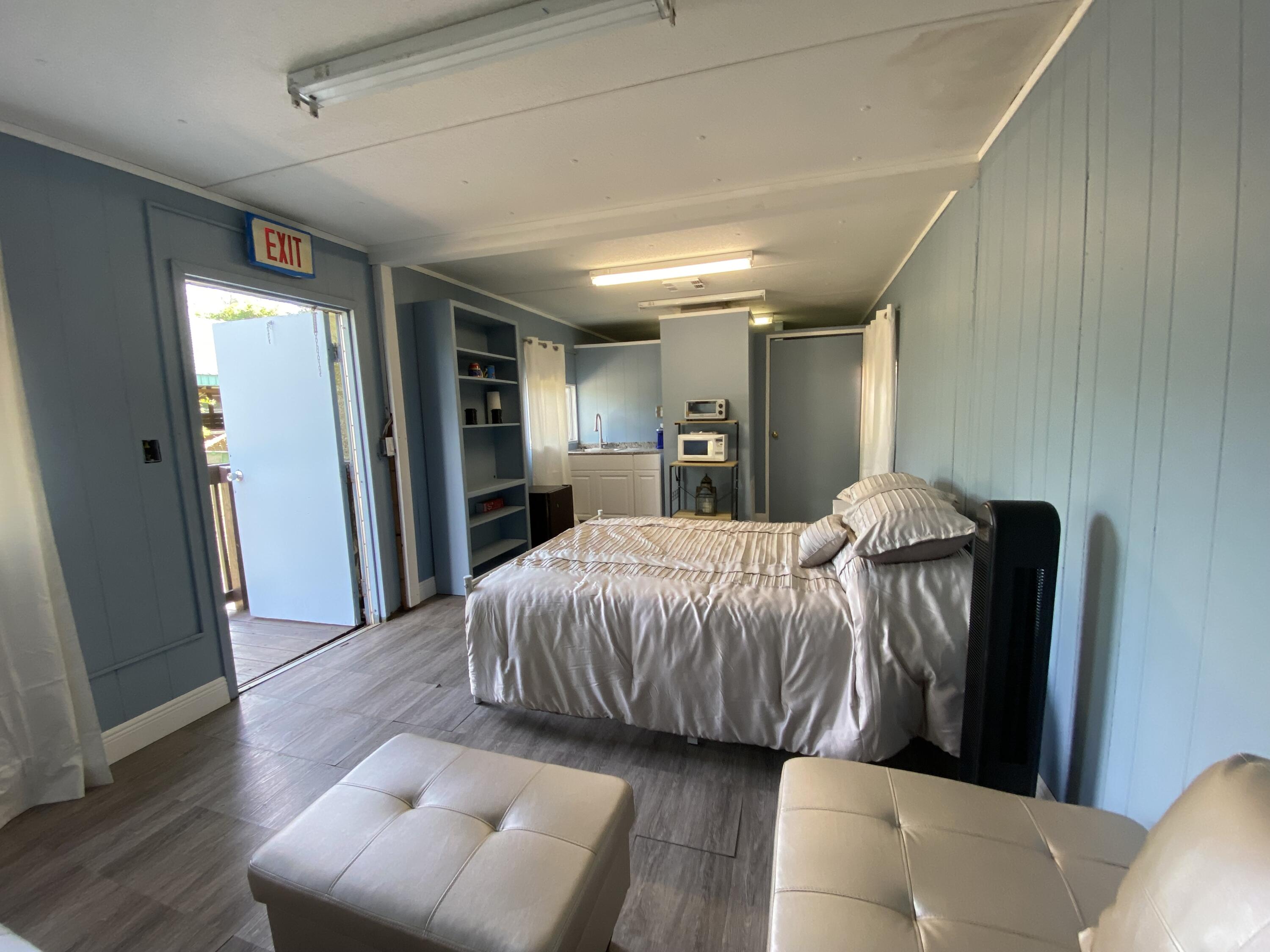 2141 B Road, Unit STUDIO 3 Loxahatchee Groves, FL 33470 - Photo 5 of 45 a bedroom with a bed and a couch