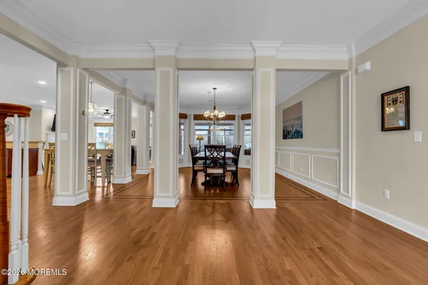 a view of staircase with railing and chandelier