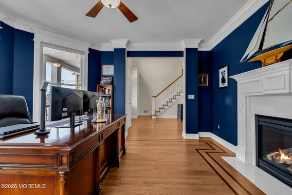 a kitchen with stainless steel appliances granite countertop a stove top oven a sink dishwasher a dining table and chairs with wooden floor