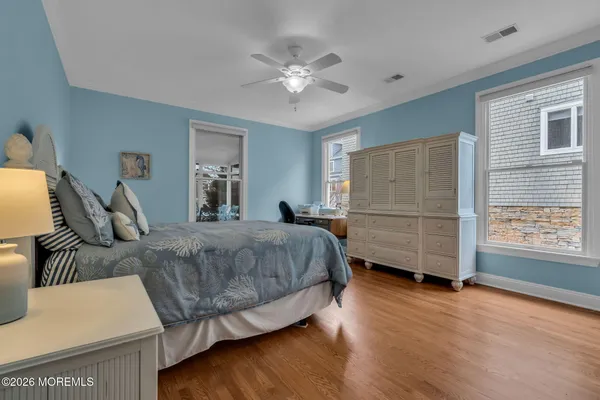 a dining hall with stainless steel appliances a dining table and chairs with wooden floor