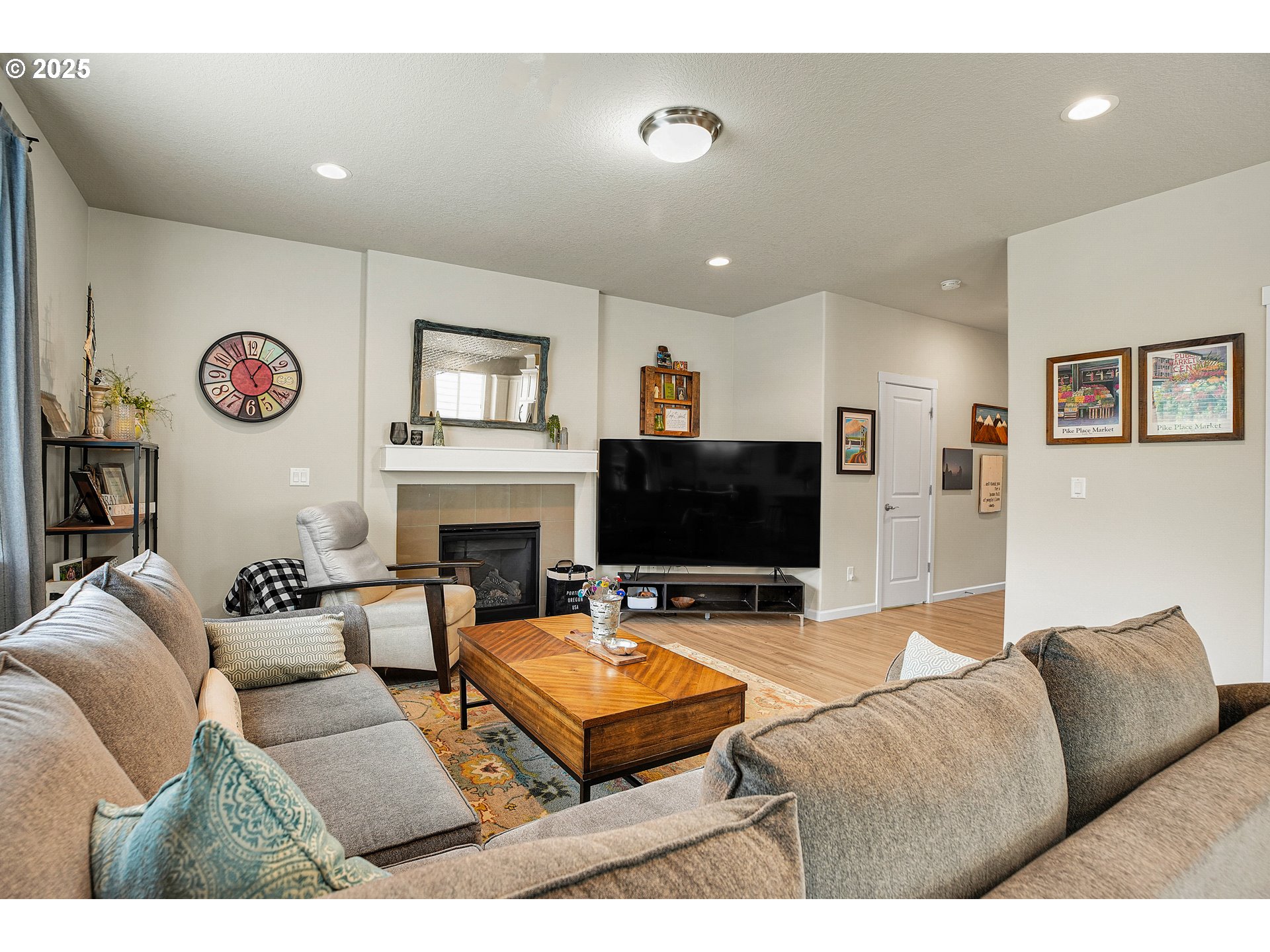 2796 Southeast Baker Avenue Gresham, OR 97080 - Photo 12 of 48 a living room with furniture flat screen tv and a fireplace