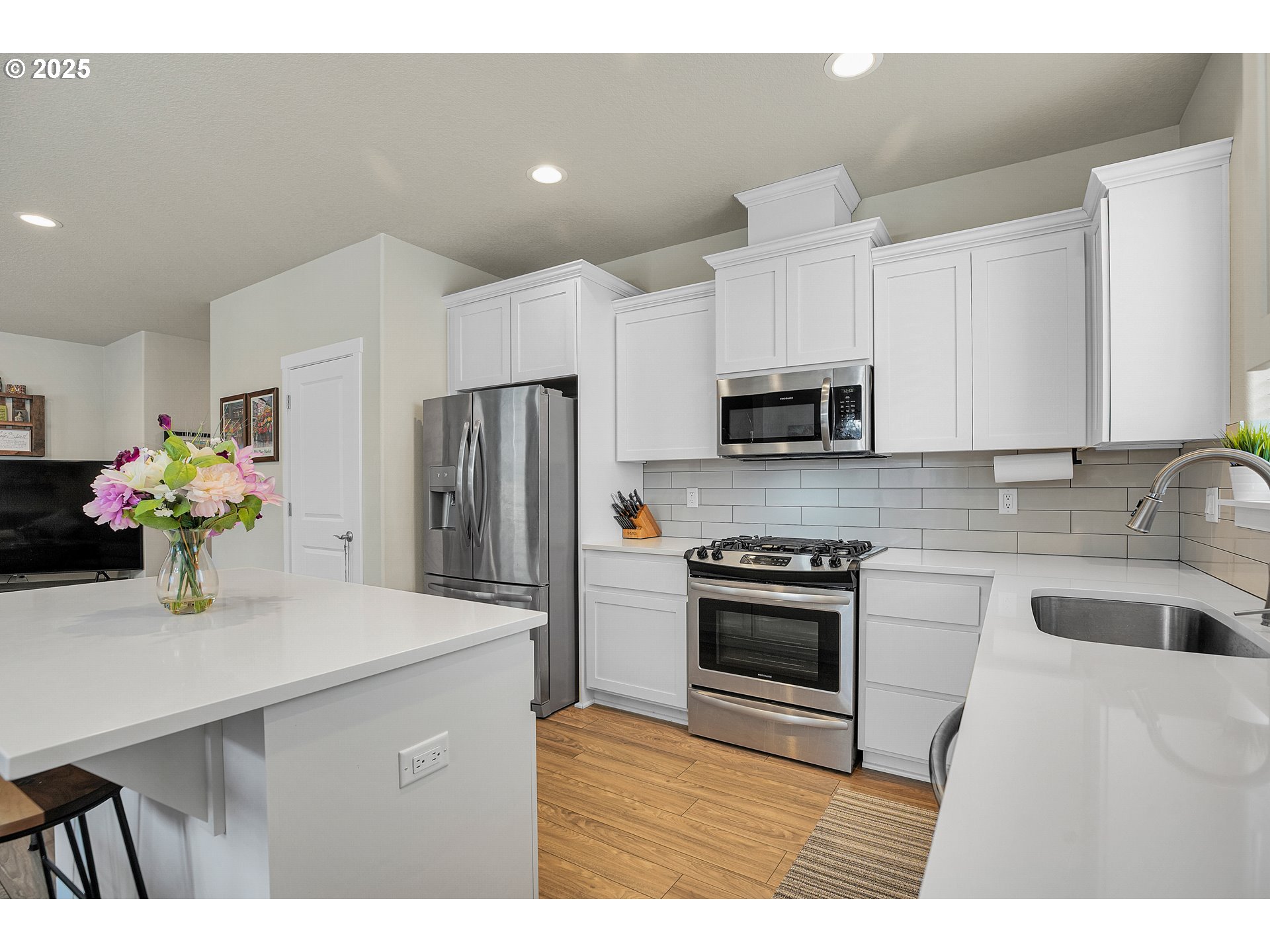 2796 Southeast Baker Avenue Gresham, OR 97080 - Photo 13 of 48 a kitchen with granite countertop white cabinets a refrigerator and a sink