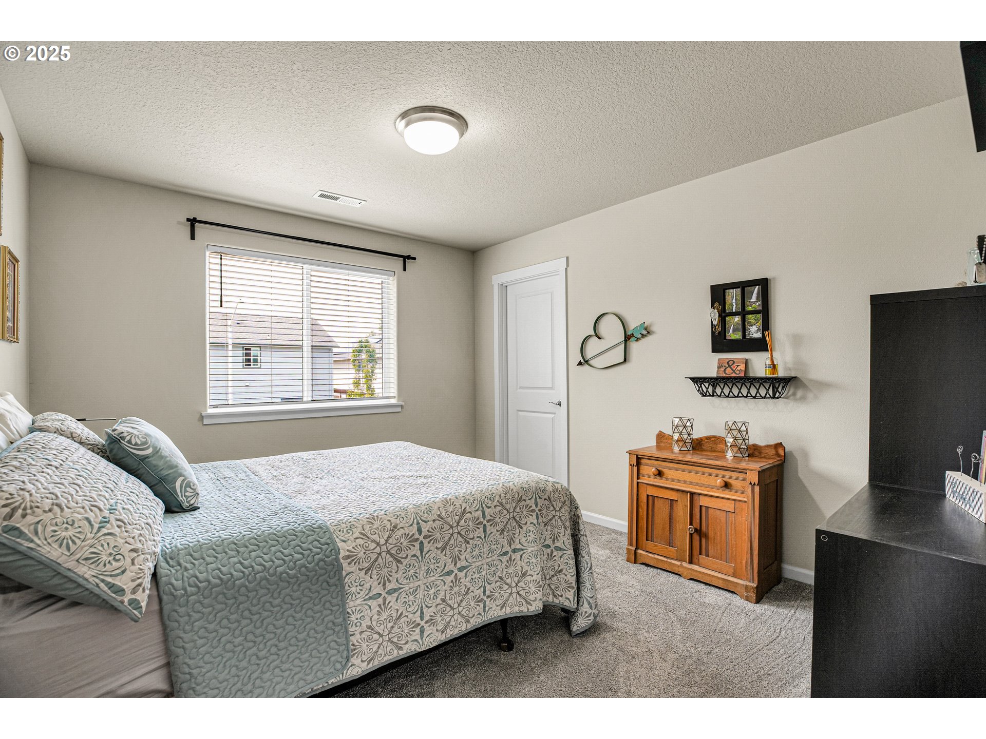 2796 Southeast Baker Avenue Gresham, OR 97080 - Photo 32 of 48 a bedroom with a bed and a flat screen tv