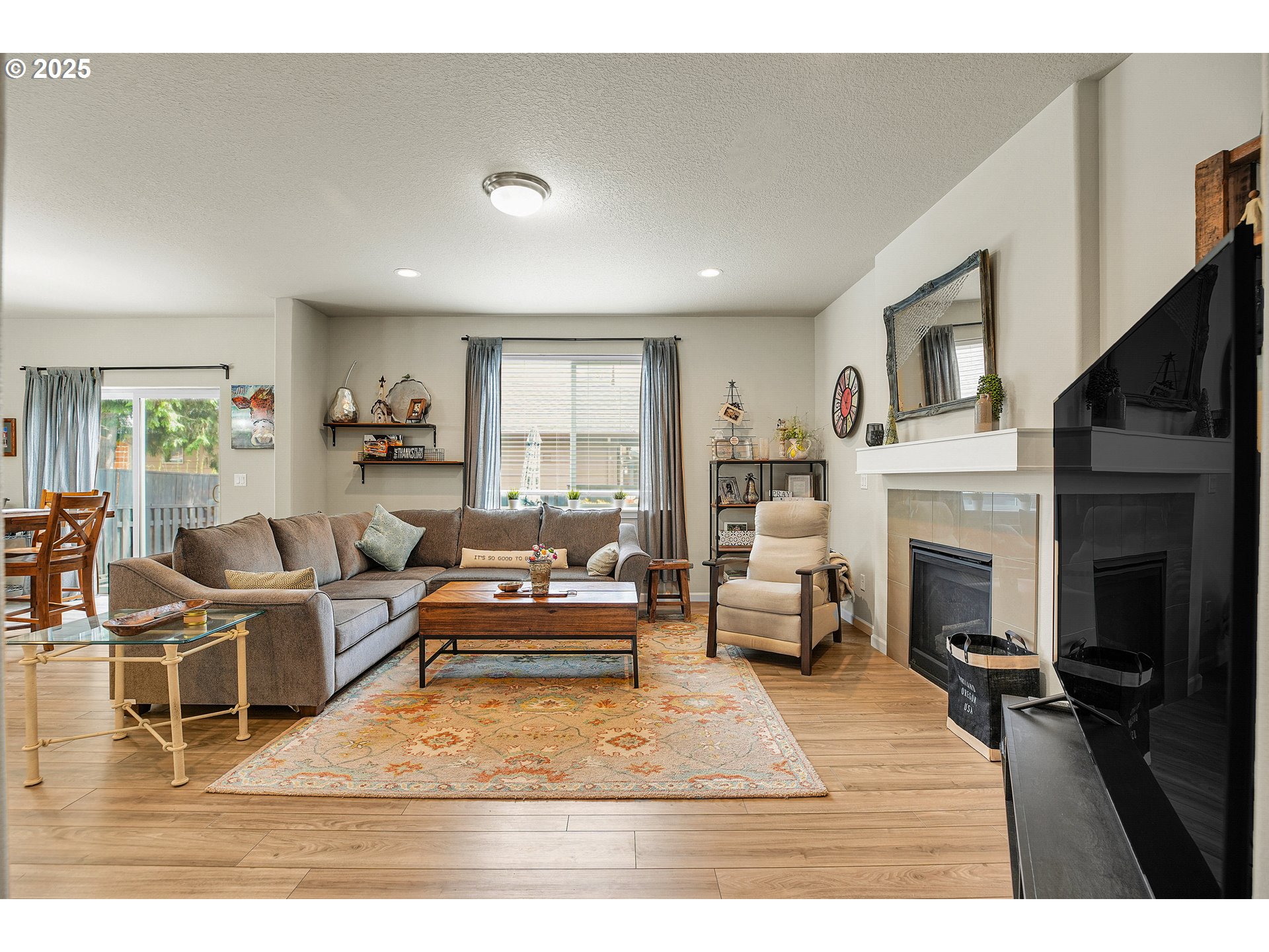 2796 Southeast Baker Avenue Gresham, OR 97080 - Photo 4 of 48 a living room with furniture large window and a fireplace