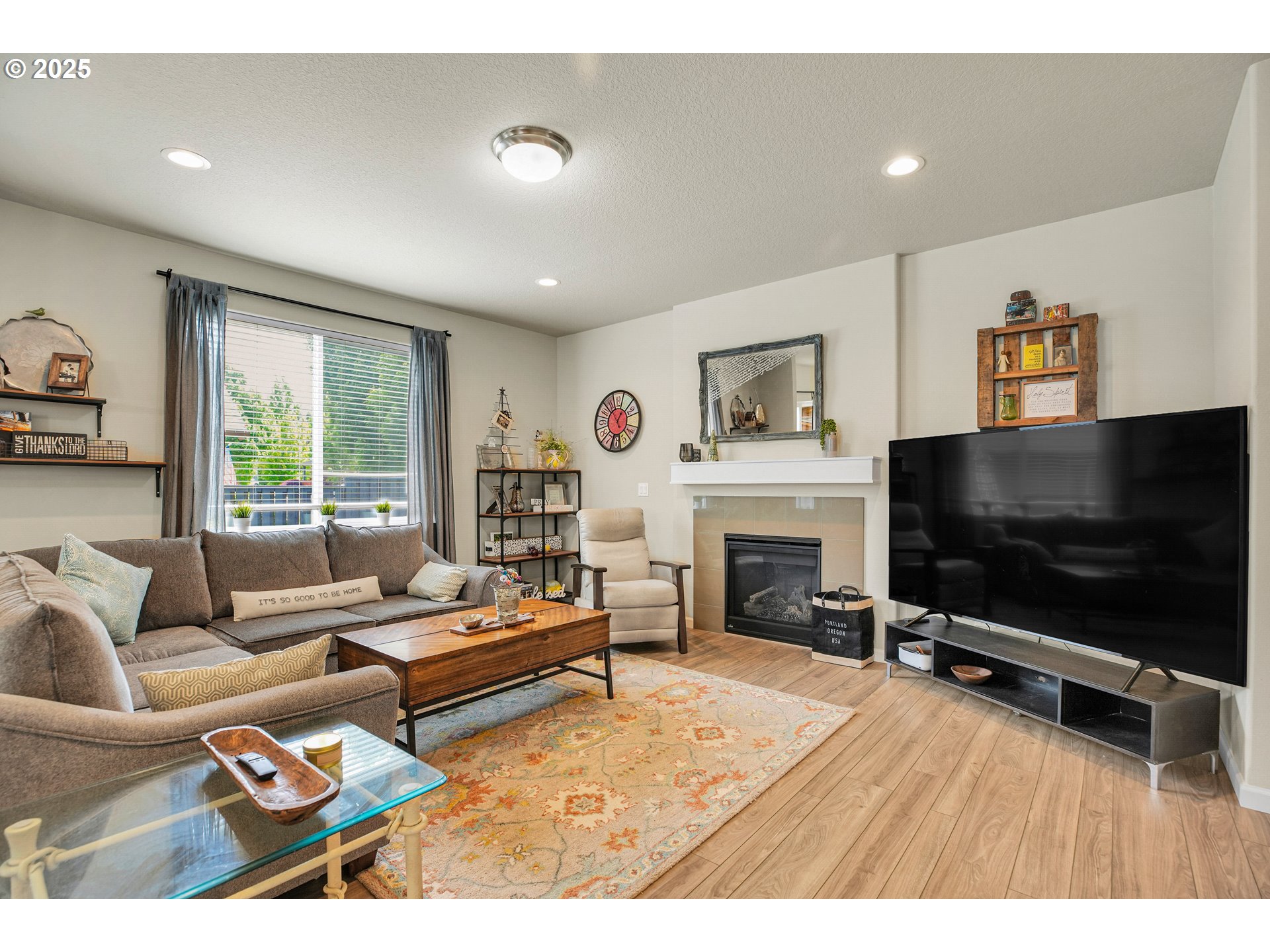 2796 Southeast Baker Avenue Gresham, OR 97080 - Photo 7 of 48 a living room with furniture a flat screen tv and a fireplace