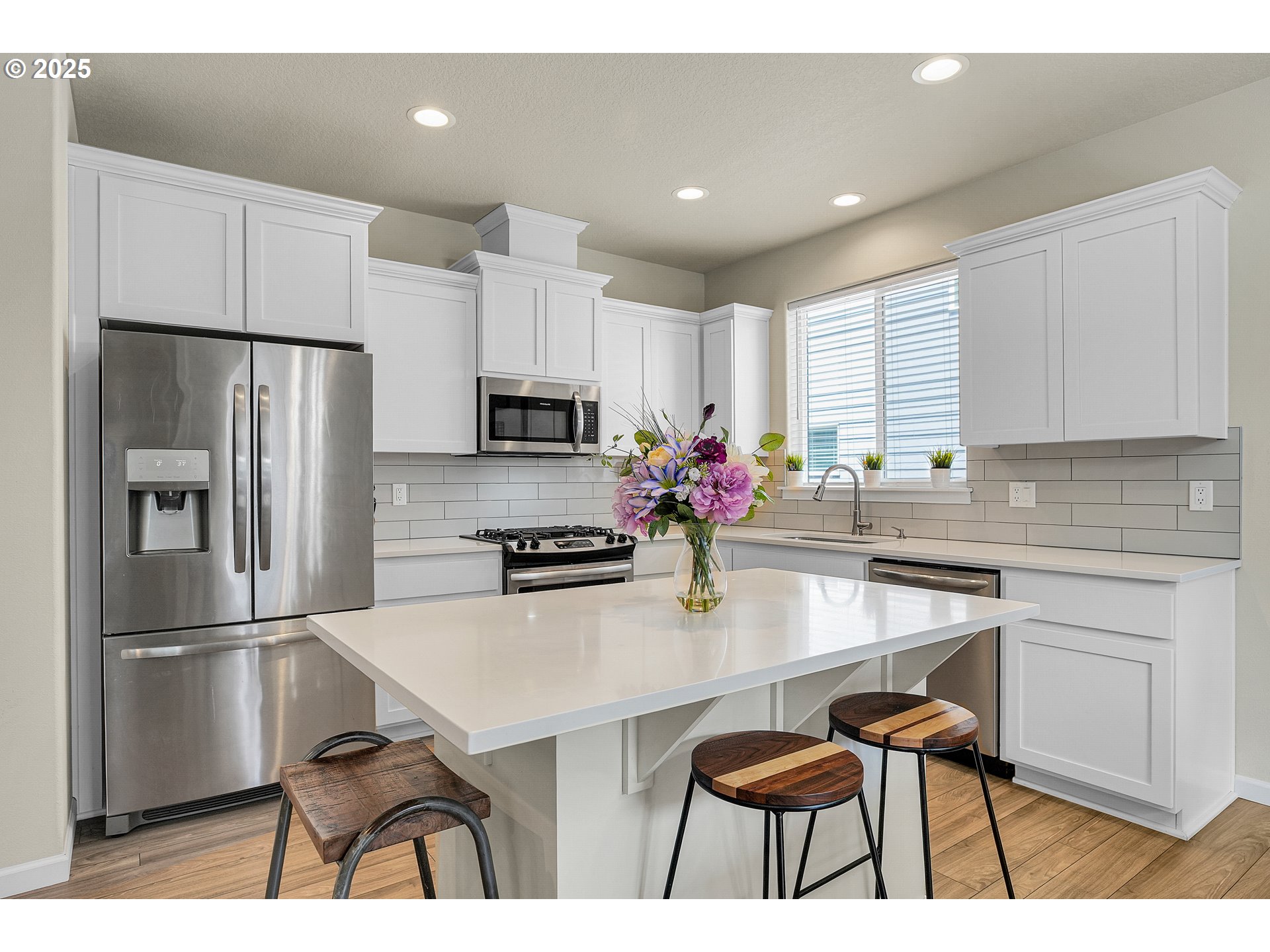 2796 Southeast Baker Avenue Gresham, OR 97080 - Photo 9 of 48 a kitchen with stainless steel appliances a dining table chairs refrigerator and sink