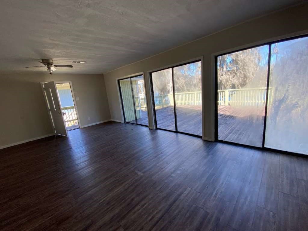 201 Ferguson Drive Cleveland, TX 77327 - Photo 6 of 27 a view of an empty room with wooden floor and a window