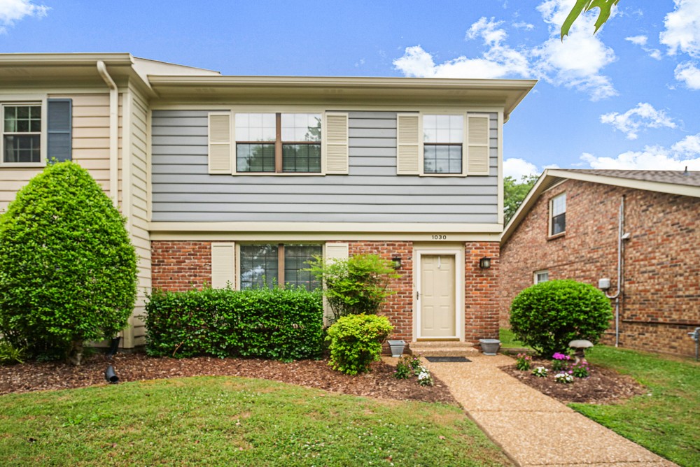 1030 General George Patton Road Nashville, TN 37221 - Photo 1 of 31 a front view of a house with a yard and potted plants