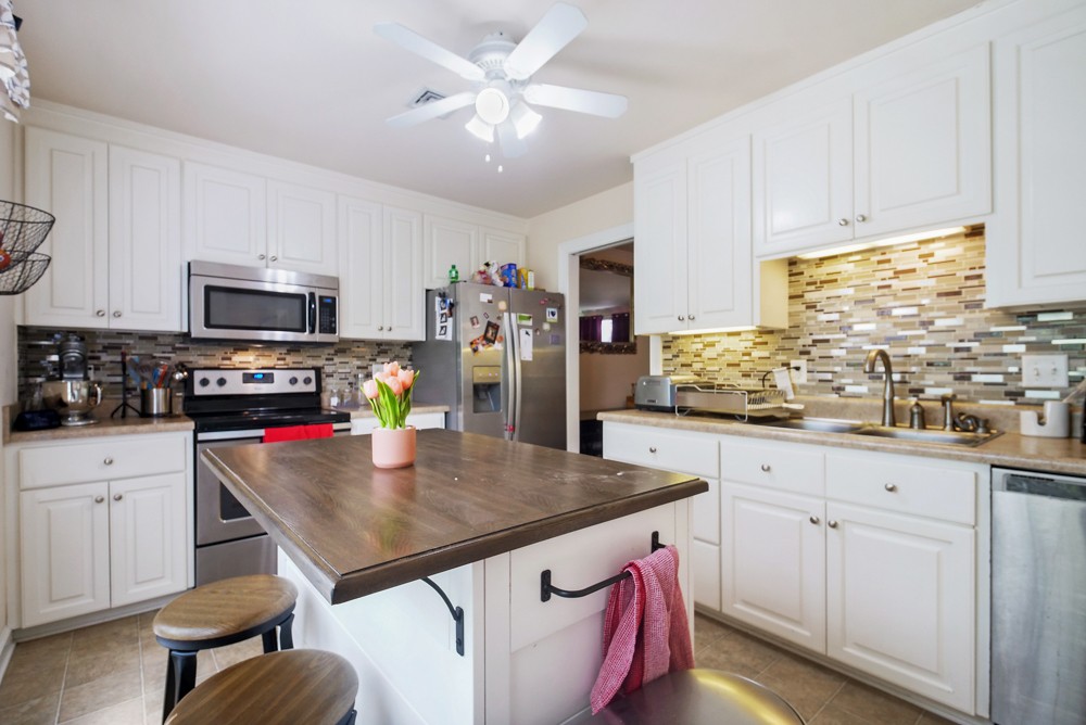 1030 General George Patton Road Nashville, TN 37221 - Photo 6 of 31 a kitchen with kitchen island granite countertop a sink a center island and cabinets
