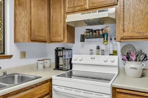 a kitchen with a refrigerator and a sink