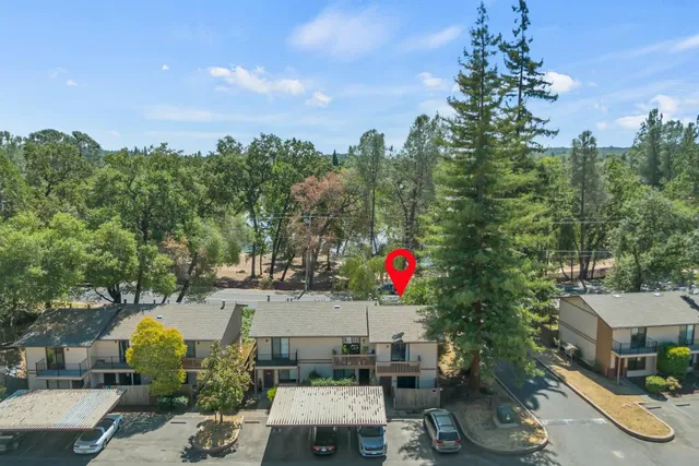 a view of a house with a yard and sitting area