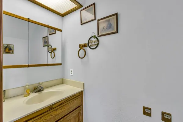 a bathroom with a granite countertop sink and a mirror
