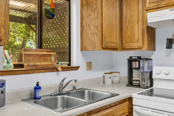 a kitchen with granite countertop a sink and a wooden cabinets