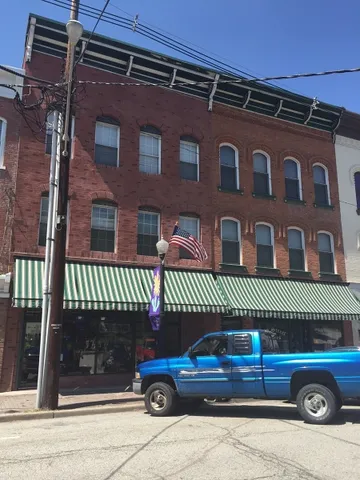 front view of a house with a small car