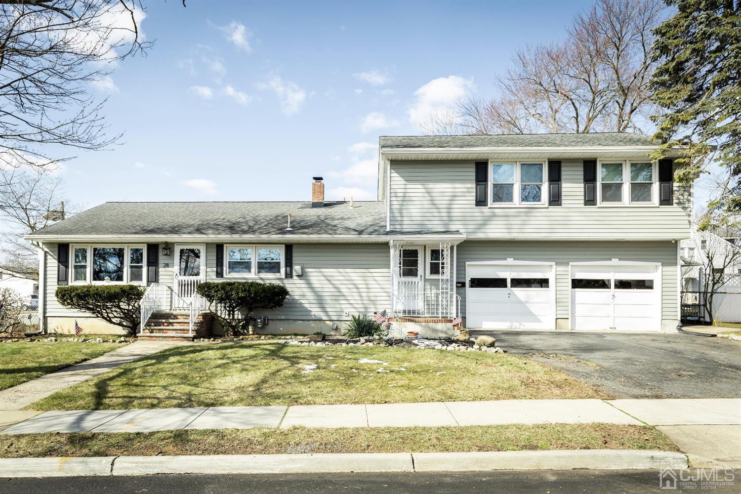 28 Melville Road Edison, NJ 08817 - Photo 1 of 52 a front view of a house with a garden and trees