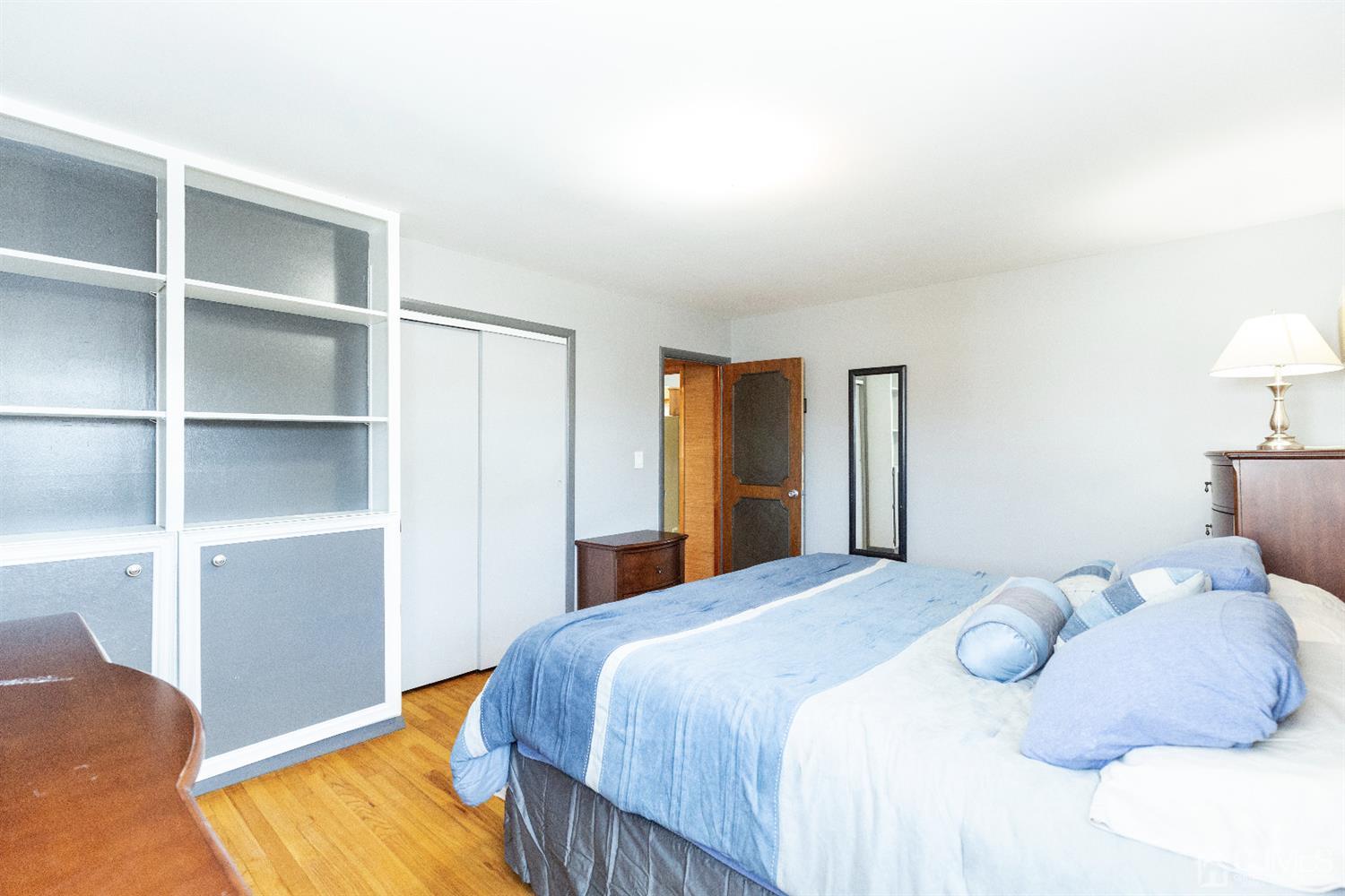 28 Melville Road Edison, NJ 08817 - Photo 13 of 52 a bedroom with a bed and a lamp